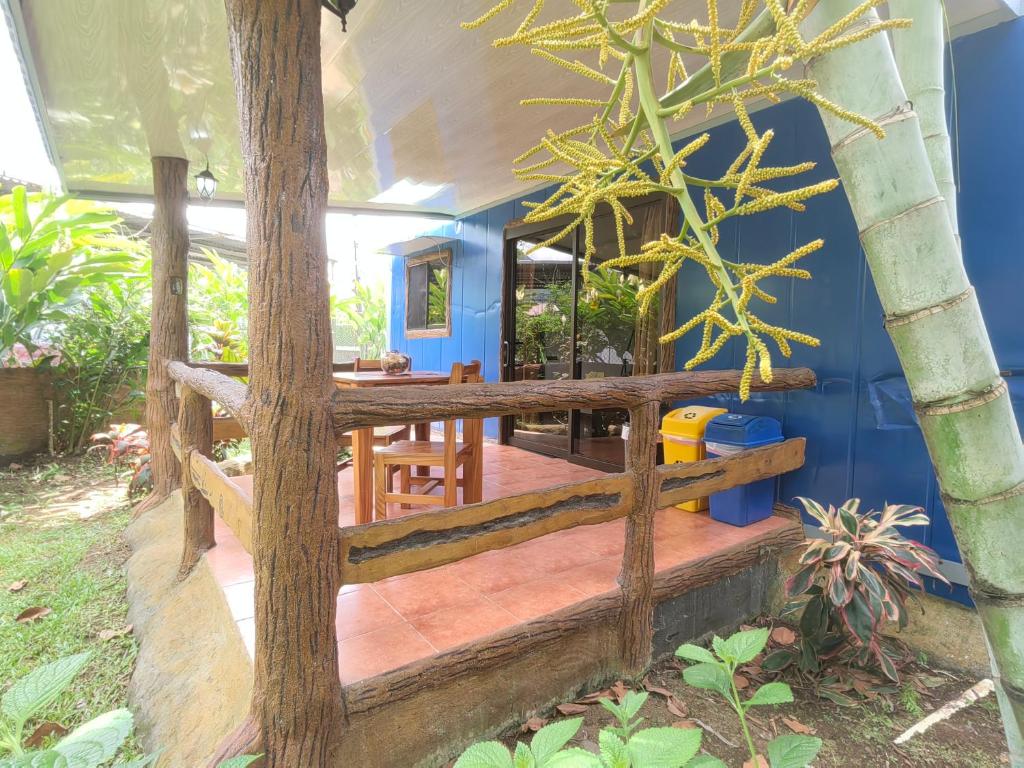 a porch of a house with a wooden railing at Arenal Homes La Fortuna in Fortuna
