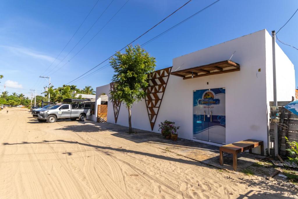 a building with a car parked outside of it at POUSADA IRMAOS ATINS in Atins