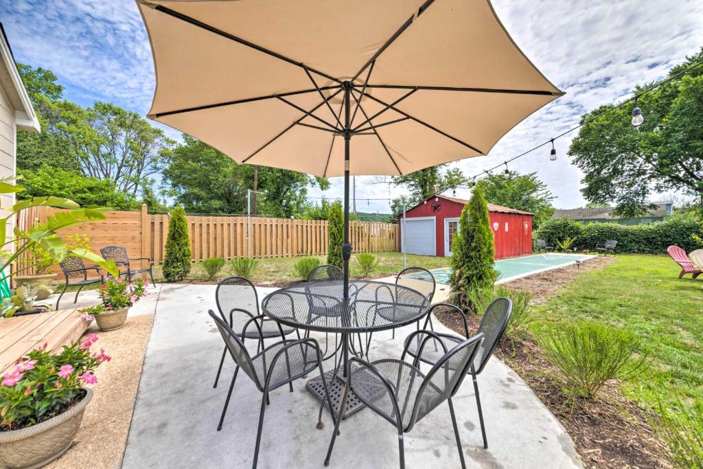 a patio with a table and chairs and an umbrella at Lucky Dawg Pet-Friendly Abode Near St Louis! in Pacific