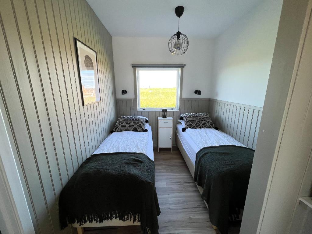 Postel nebo postele na pokoji v ubytování Garður Apartments