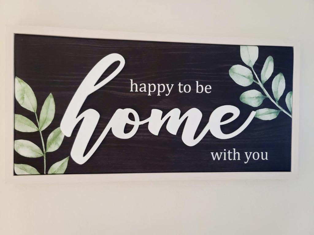 a sign that says happy to be home with you at Phoenix Comfort home II in Phoenix