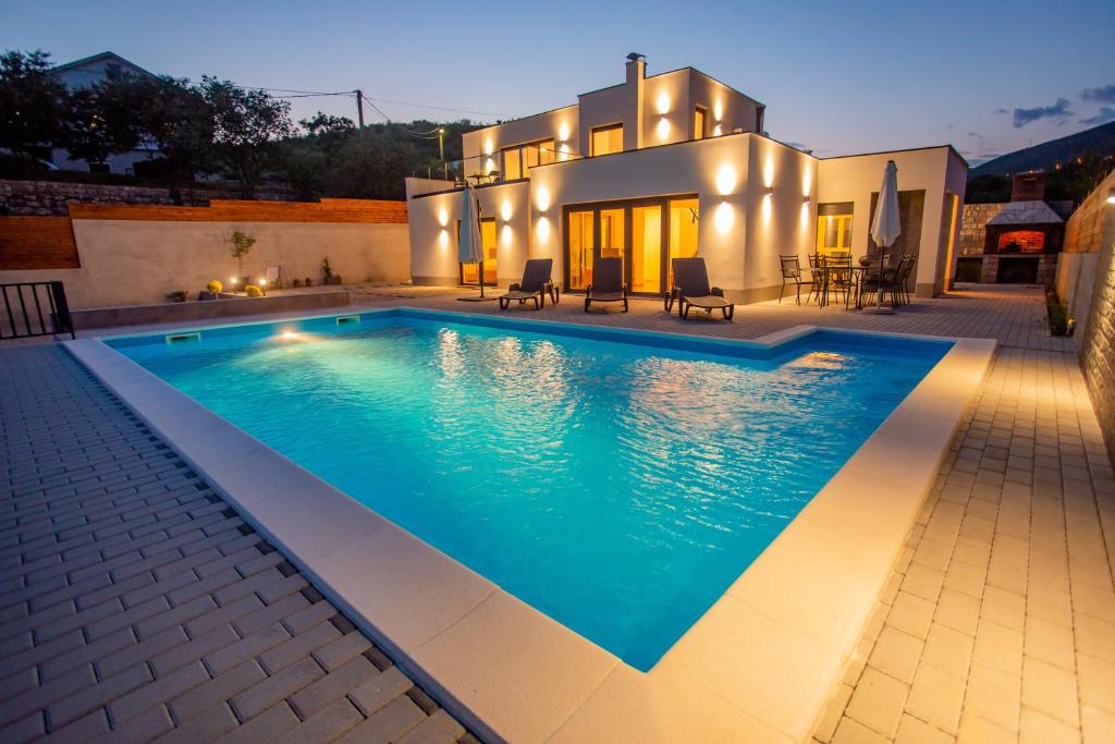 - une piscine en face d'une maison dans l'établissement Villa Bianca, à Blagaj