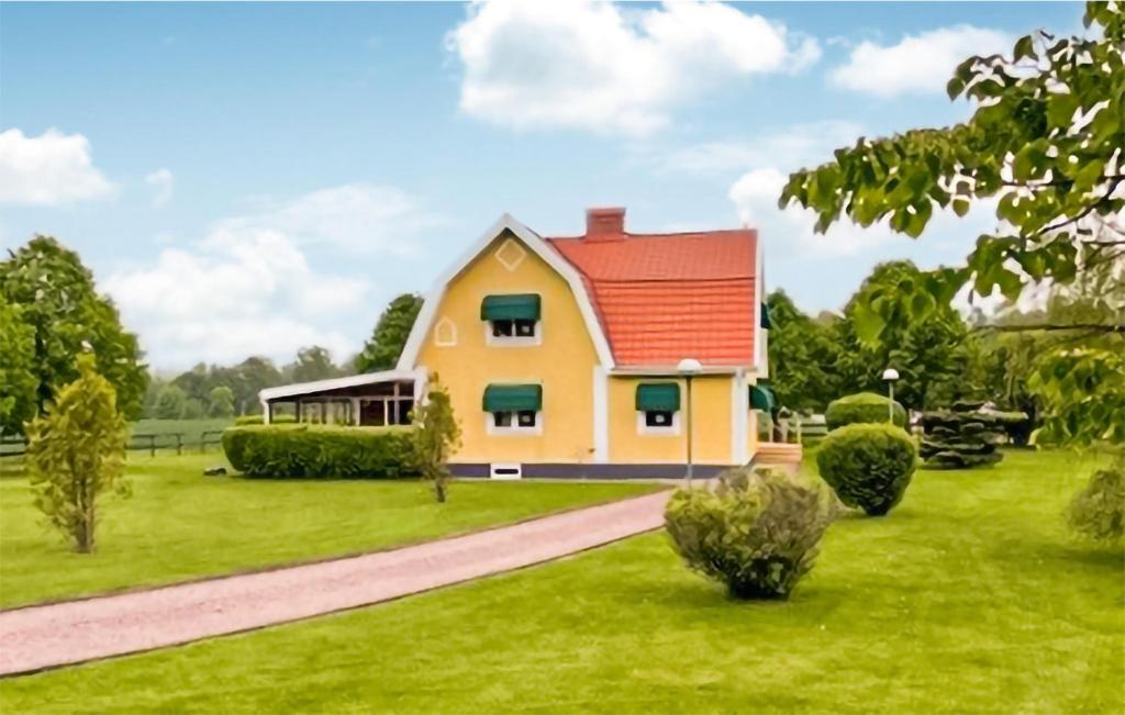 une maison avec un toit rouge sur une pelouse verte dans l'établissement Nice Apartment In Svenljunga With Sauna, à Svenljunga