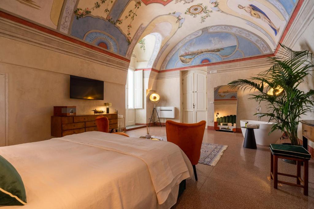 Postel nebo postele na pokoji v ubytování Relais La Casa del Poeta