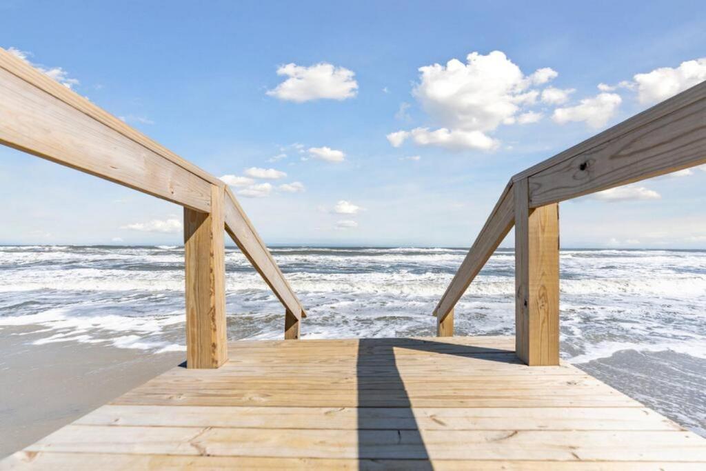 a wooden pier on the beach with the ocean at Spectacular 3 BR Condo One Block to the Beach in Brigantine