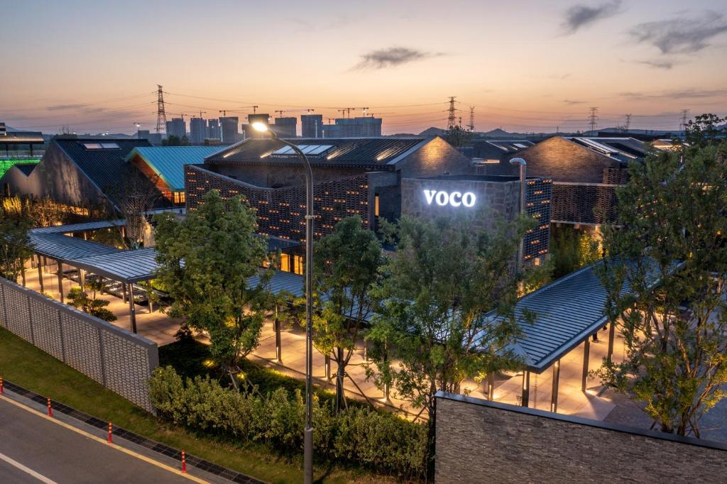 an aerial view of the voo building at night at voco Nanjing Garden Expo, an IHG Hotel in Nanjing