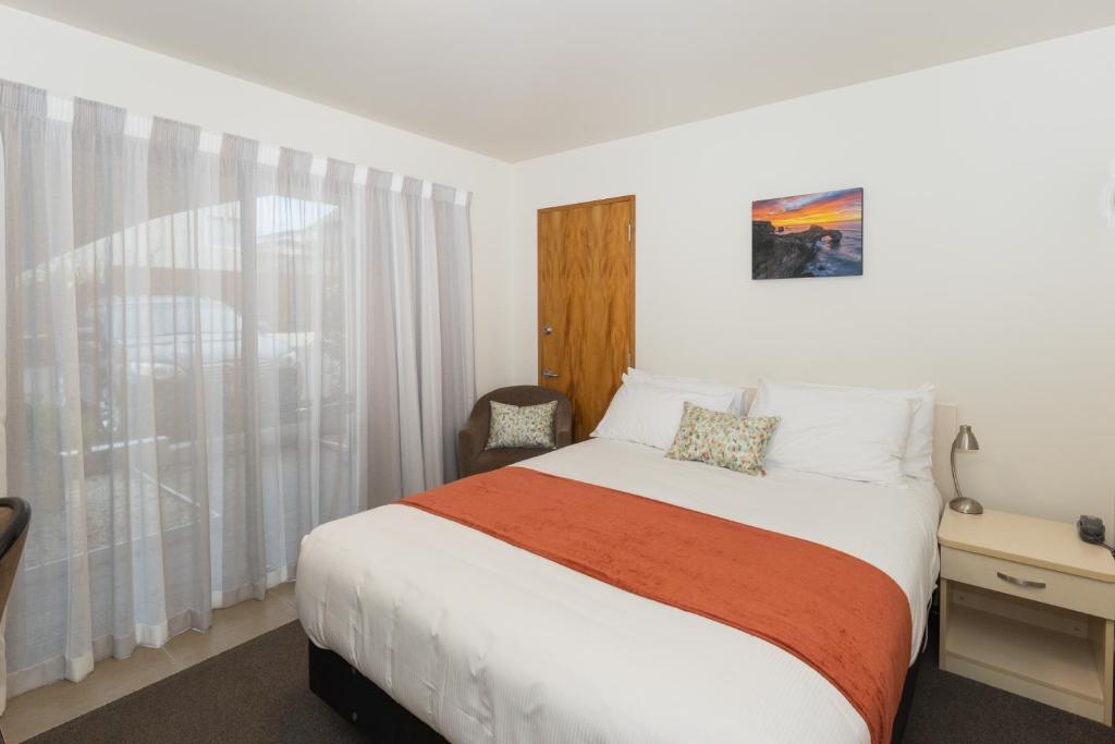 Postel nebo postele na pokoji v ubytování Bella Vista Motel Dunedin