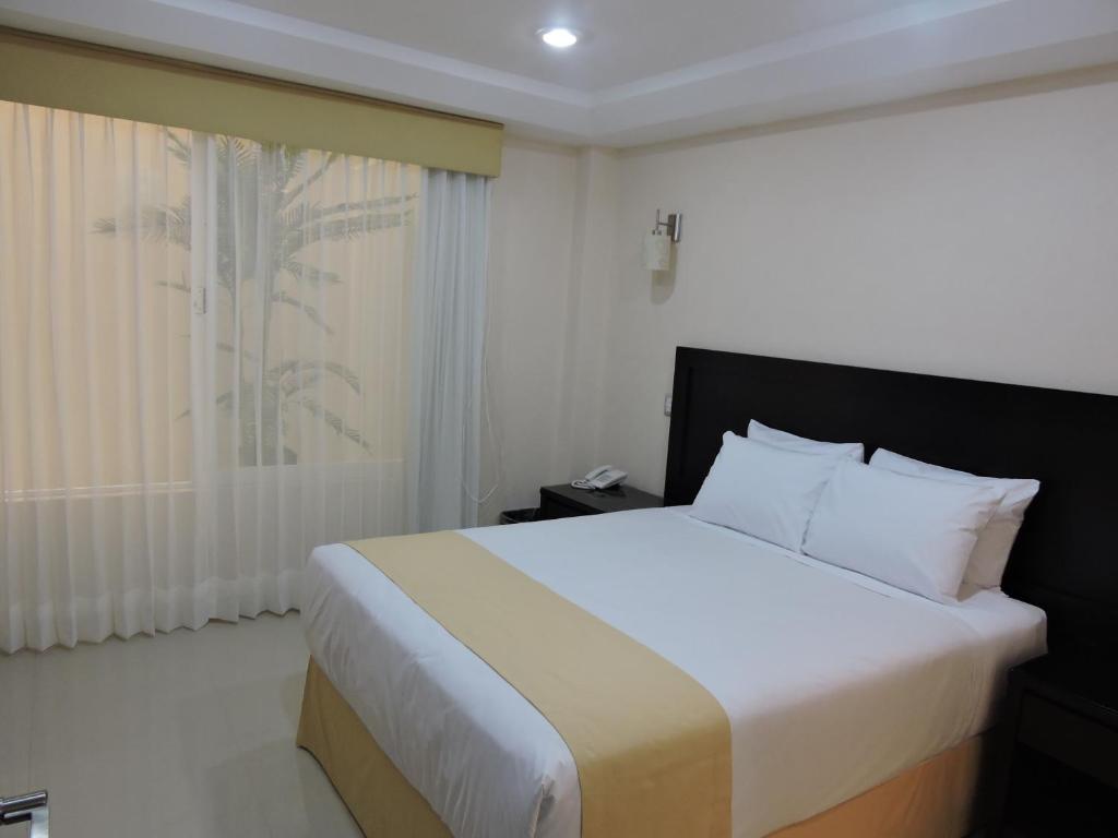 Postel nebo postele na pokoji v ubytování Casa Jasave Hotel