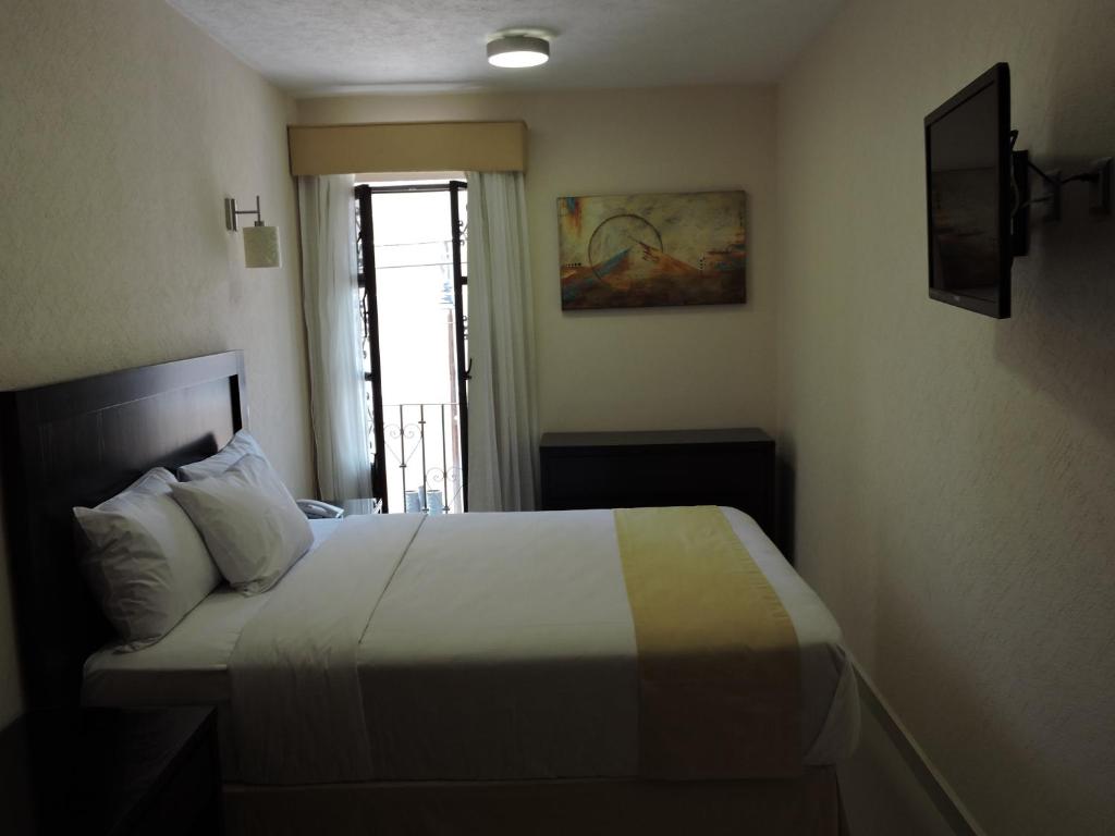 Postel nebo postele na pokoji v ubytování Casa Jasave Hotel