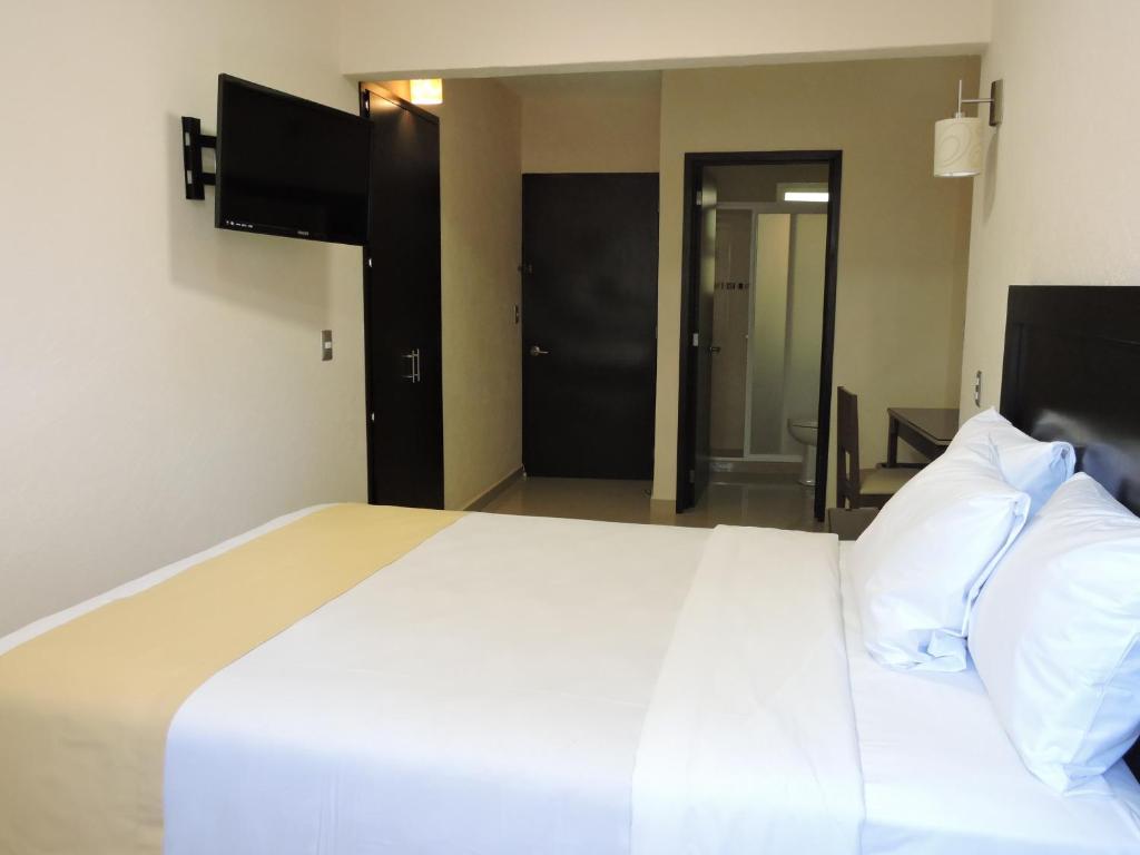 Postel nebo postele na pokoji v ubytování Casa Jasave Hotel