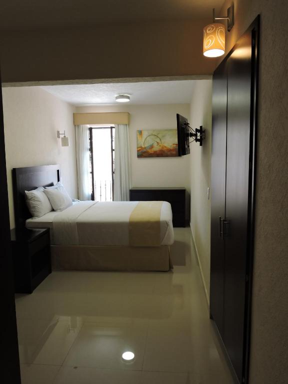 Postel nebo postele na pokoji v ubytování Casa Jasave Hotel