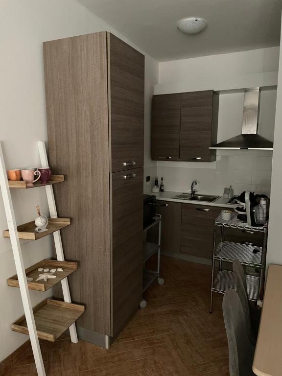 a small kitchen with a refrigerator and a kitchen table at Lamezia Park Apartments in Lamezia Terme