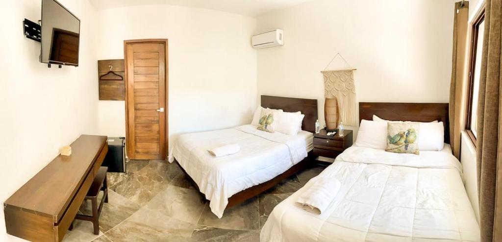 Postel nebo postele na pokoji v ubytování Hotel Sun Ha Bacalar