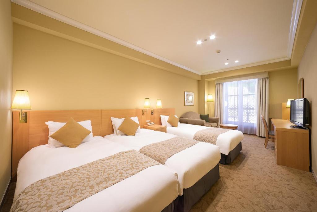 Postel nebo postele na pokoji v ubytování Namba Oriental Hotel