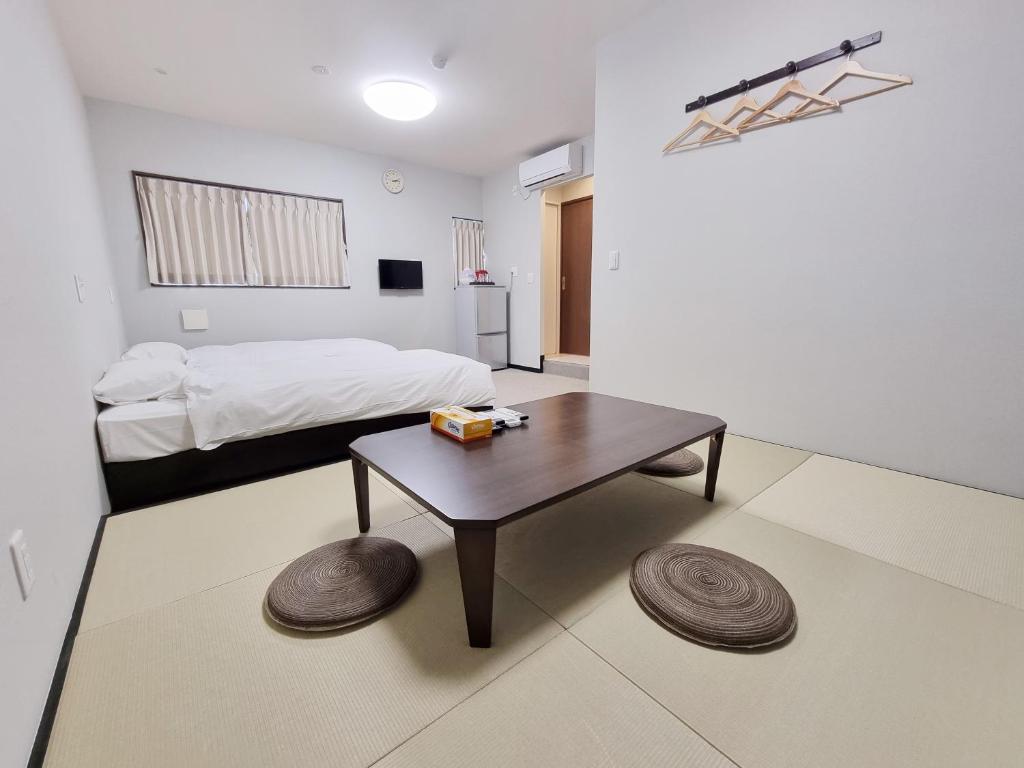Posteľ alebo postele v izbe v ubytovaní KYU KYU HOTEL