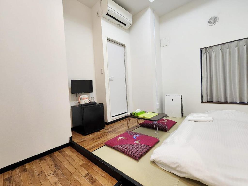 Posteľ alebo postele v izbe v ubytovaní KYU KYU HOTEL