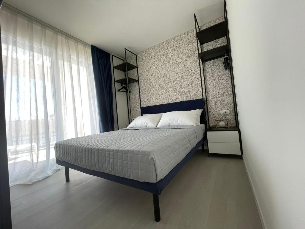 a bedroom with a bed and a large window at MAR60 Apartments in Caorle