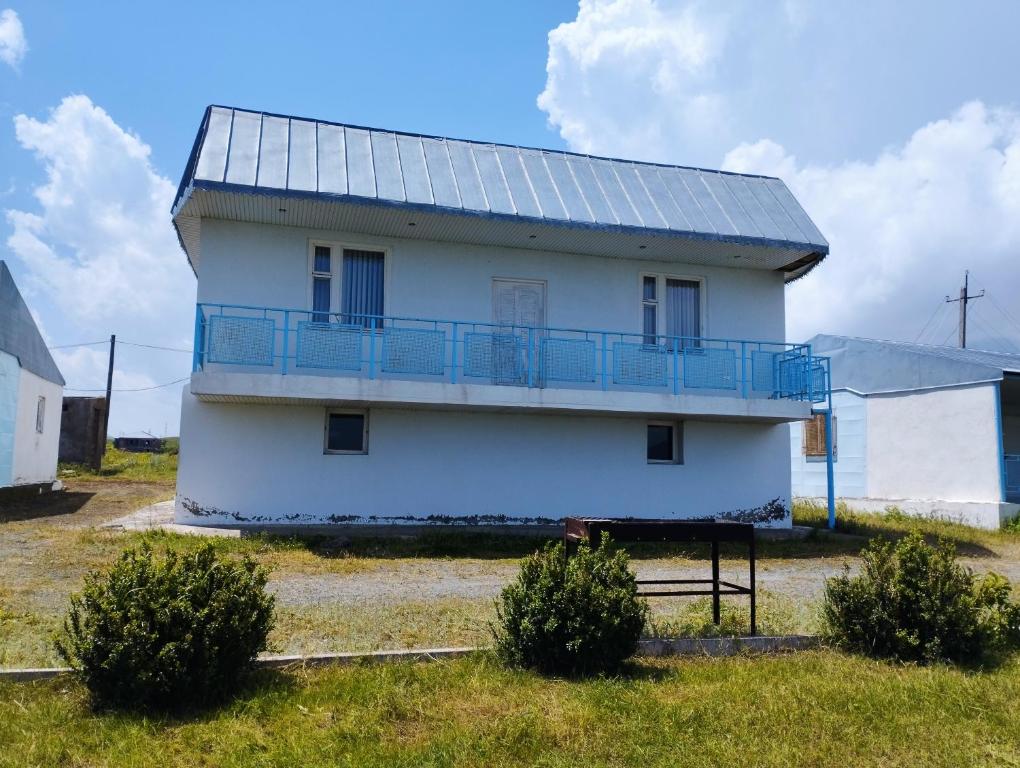 a white house with a solar panel on it at Sevan - White House in Sevan