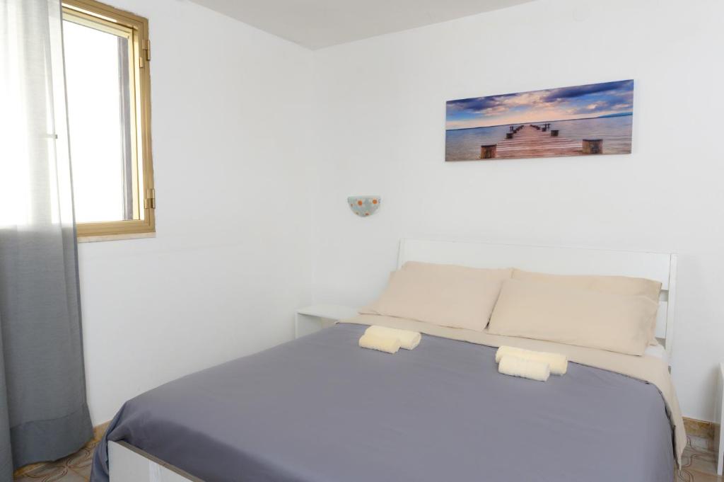 Postel nebo postele na pokoji v ubytování Salento incantevole alloggio fronte mare