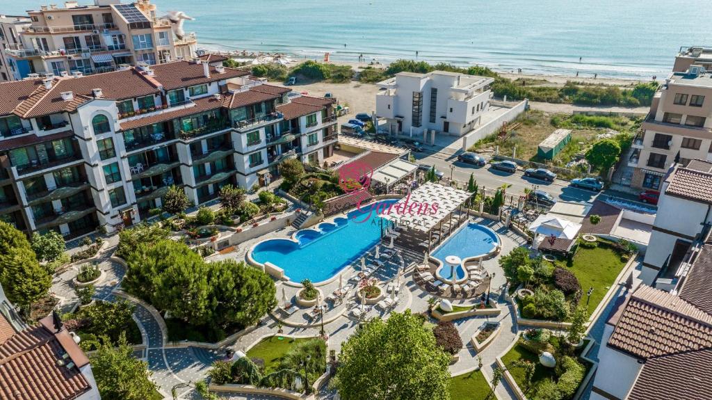 an aerial view of a resort with a pool and the beach at Rose Gardens Apart Hotel in Pomorie