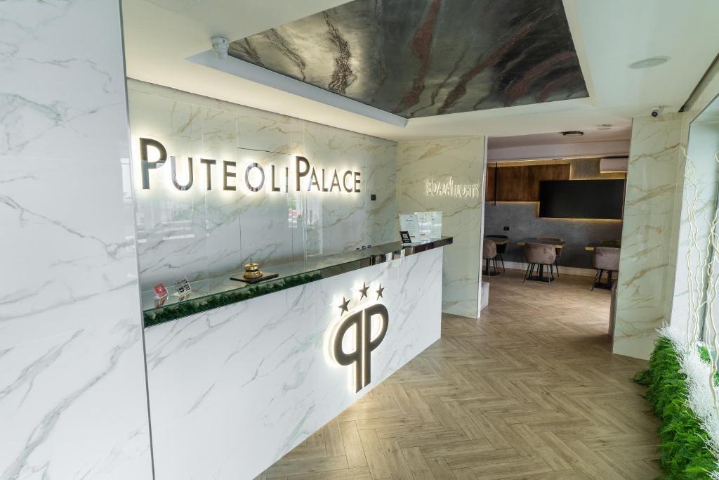 a lobby of a hotel with aip sign on the wall at Puteoli Palace Hotel in Pozzuoli