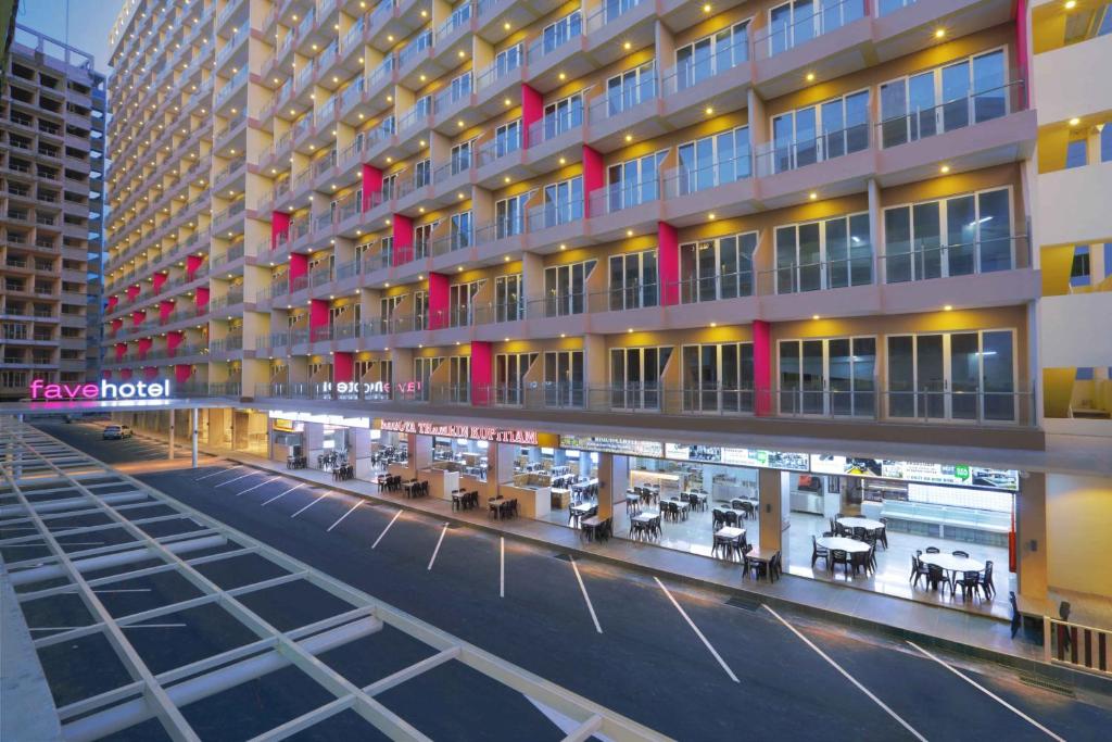 a view of a building with tables in front of it at favehotel Nagoya - Batam in Batam Center