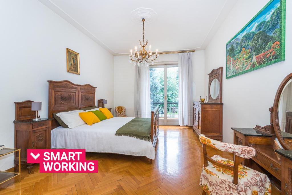 a bedroom with a bed and a chandelier at Crocetta Family Apartment by Wonderful Italy in Turin