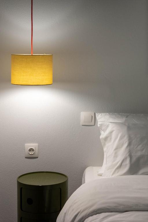 a bedroom with a bed and a table and a lamp at Paleokastritsa Red Gate Flat in Paleokastritsa