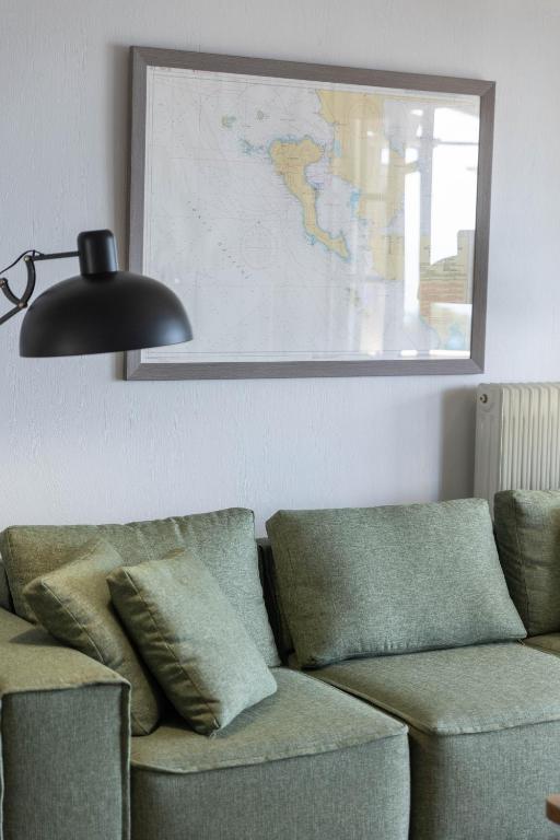 a living room with a couch and a map on the wall at Paleokastritsa Red Gate Flat in Paleokastritsa