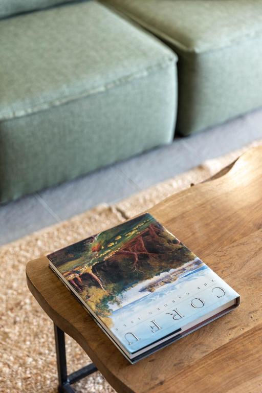 a book sitting on a table next to a couch at Paleokastritsa Red Gate Flat in Paleokastritsa