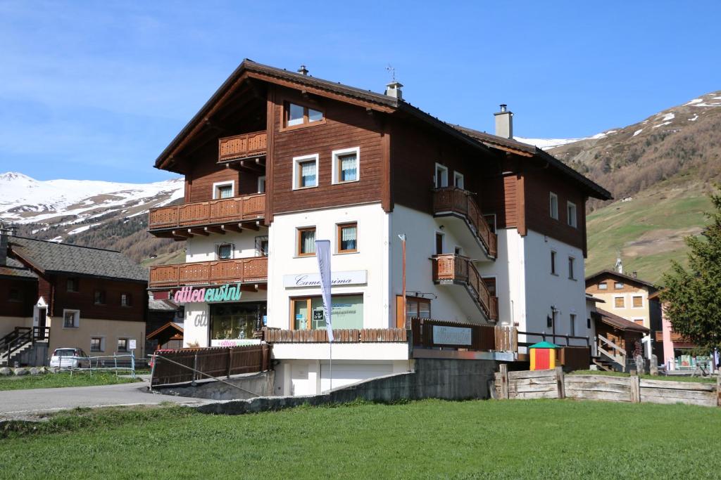 a large building with a brown and white at Bike&Ski Centro Apartments in Livigno