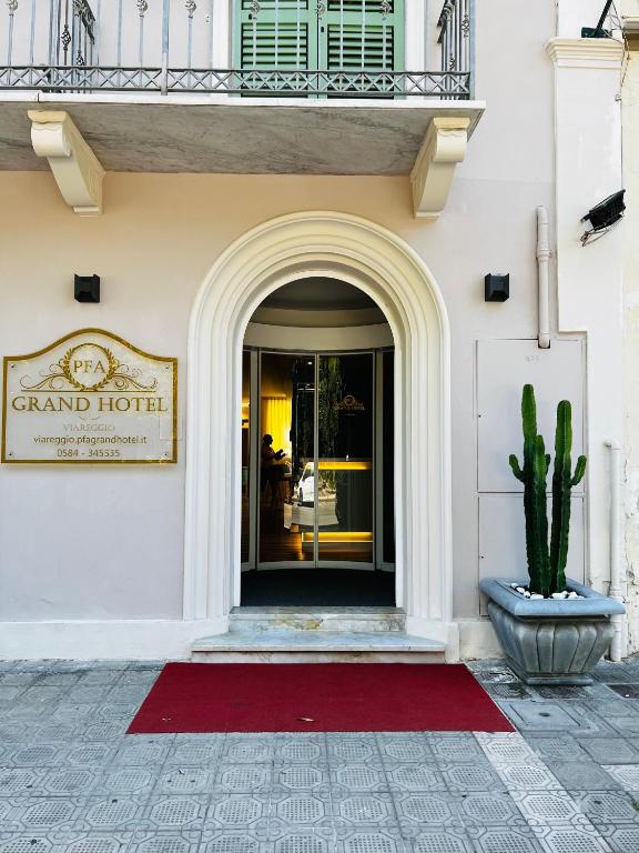 a front door of a grand hotel with a cactus at PFA Hotel Viareggio in Viareggio
