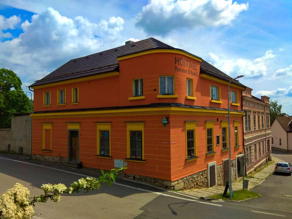 an orange building on the side of a street at Hostinec a penzion U Rezků in Jistebnice