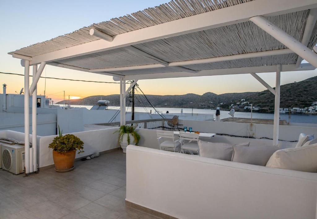 a balcony with white furniture and a view of the ocean at Villa Katapoliani I in Katapola