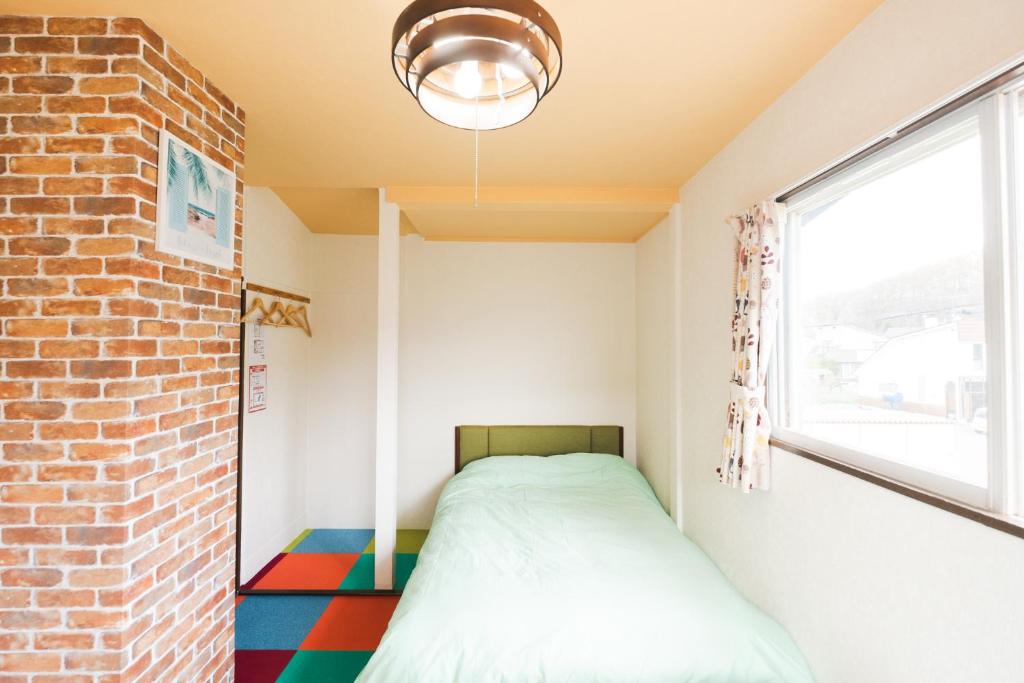 Postel nebo postele na pokoji v ubytování 旭川美瑛 Sakura 西神楽