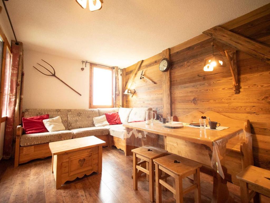 a living room with a couch and a table at Appartement Valmorel, 1 pièce, 4 personnes - FR-1-291-710 in Valmorel