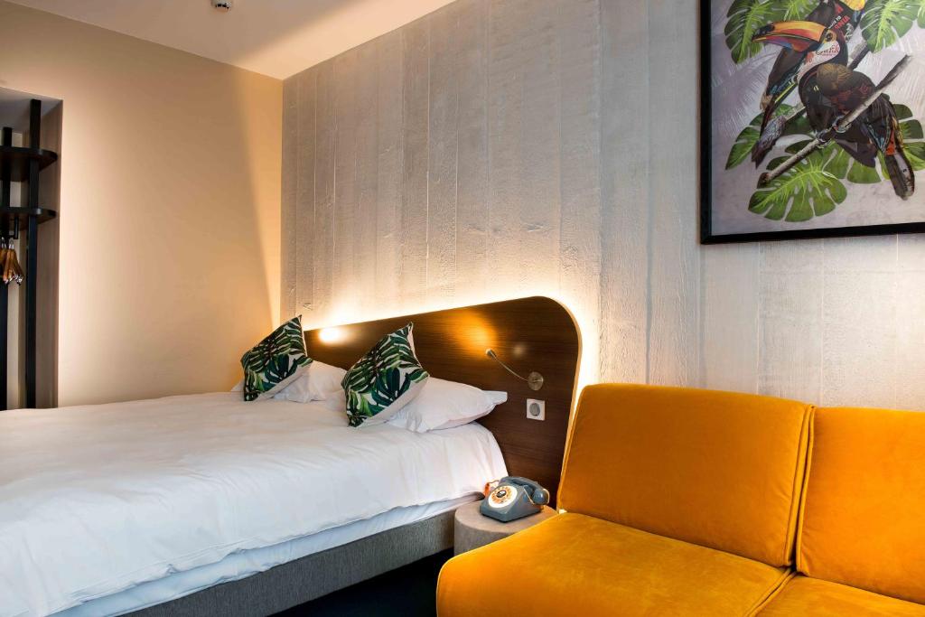 Postel nebo postele na pokoji v ubytování KOPSTER Hotel Lyon Groupama Stadium