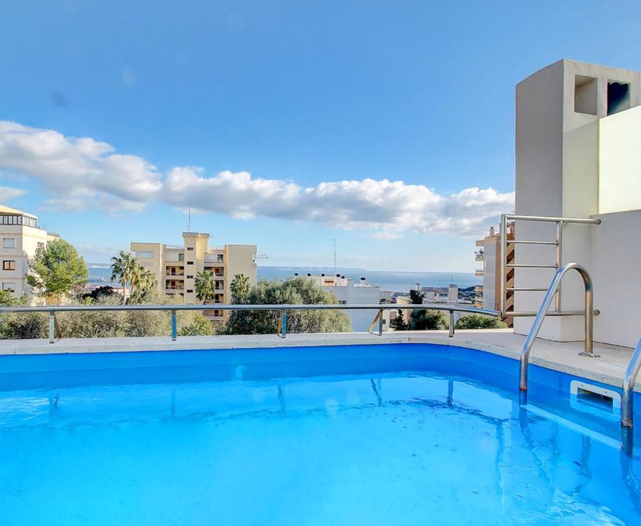a swimming pool on a balcony with a view of the ocean at VILLA BONANOVA STYLE in Palma de Mallorca