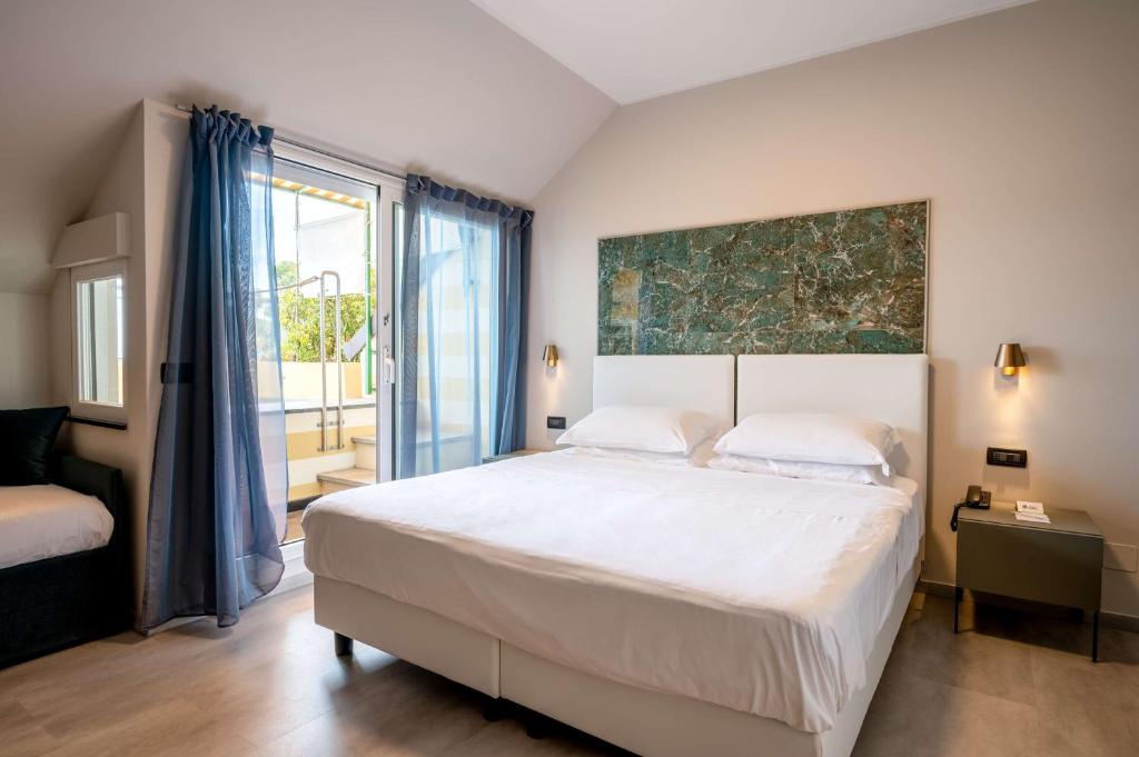 Postel nebo postele na pokoji v ubytování Best Western Regina Elena