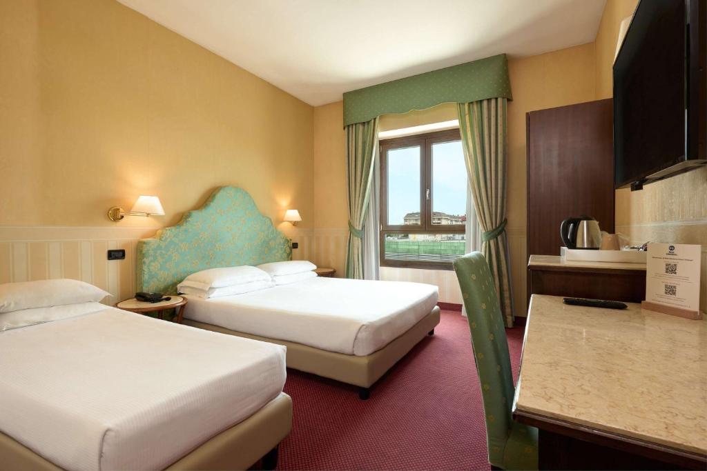 Postel nebo postele na pokoji v ubytování Best Western Hotel Tritone
