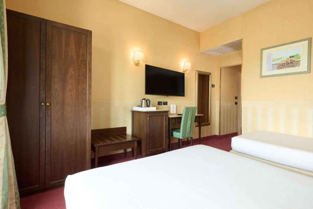 Postel nebo postele na pokoji v ubytování Best Western Hotel Tritone