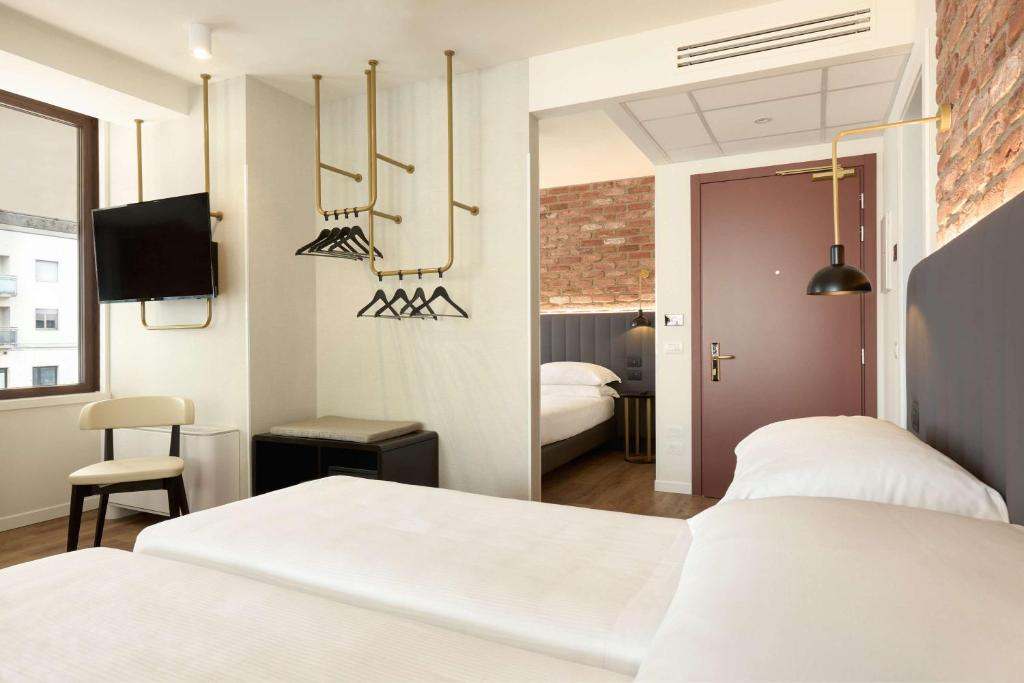 Postel nebo postele na pokoji v ubytování Best Western Hotel Tritone