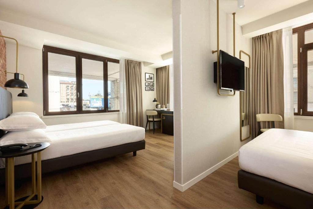 Postel nebo postele na pokoji v ubytování Best Western Hotel Tritone