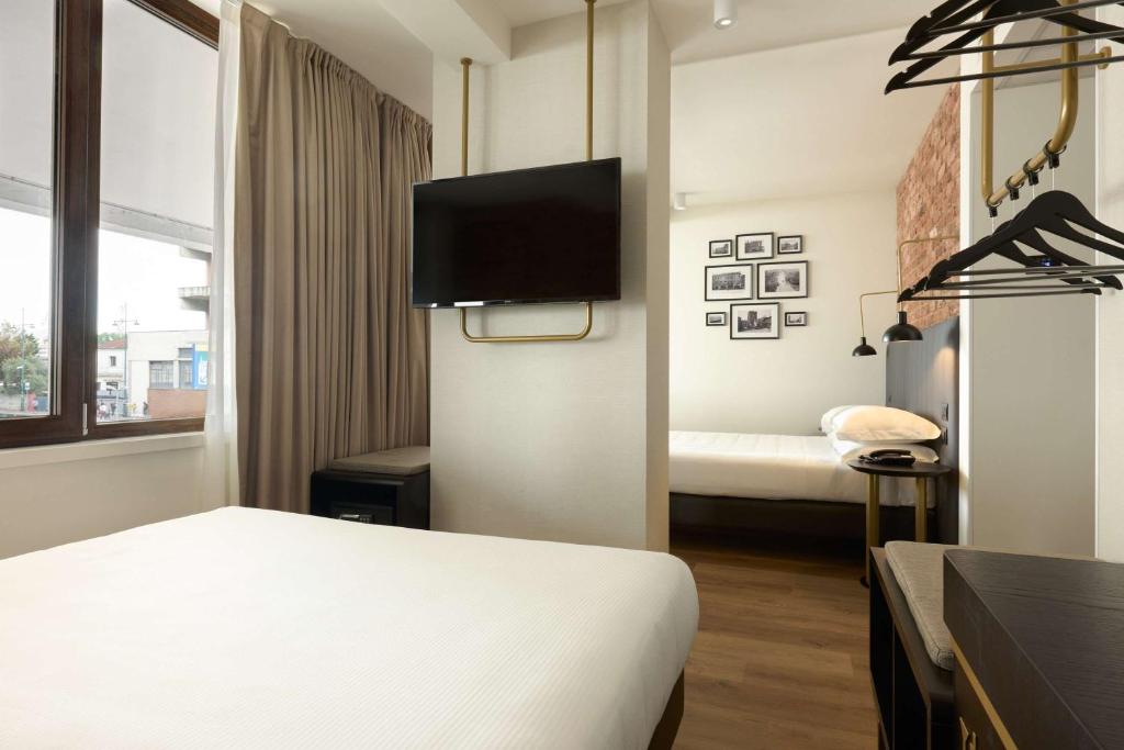 Postel nebo postele na pokoji v ubytování Best Western Hotel Tritone