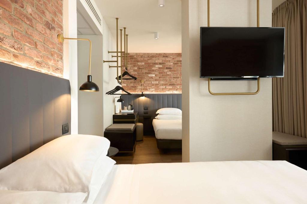 Postel nebo postele na pokoji v ubytování Best Western Hotel Tritone