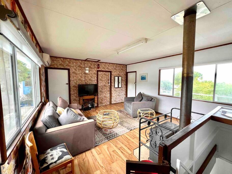 a living room with a couch and a television at Retro Margaret River Beach Shack in Prevelly Park in Prevelly