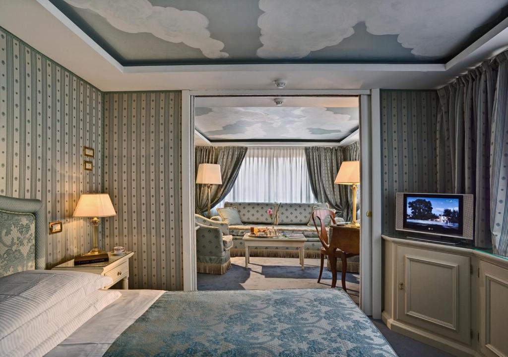 a bedroom with a bed and a living room at Hotel Biasutti in Venice-Lido