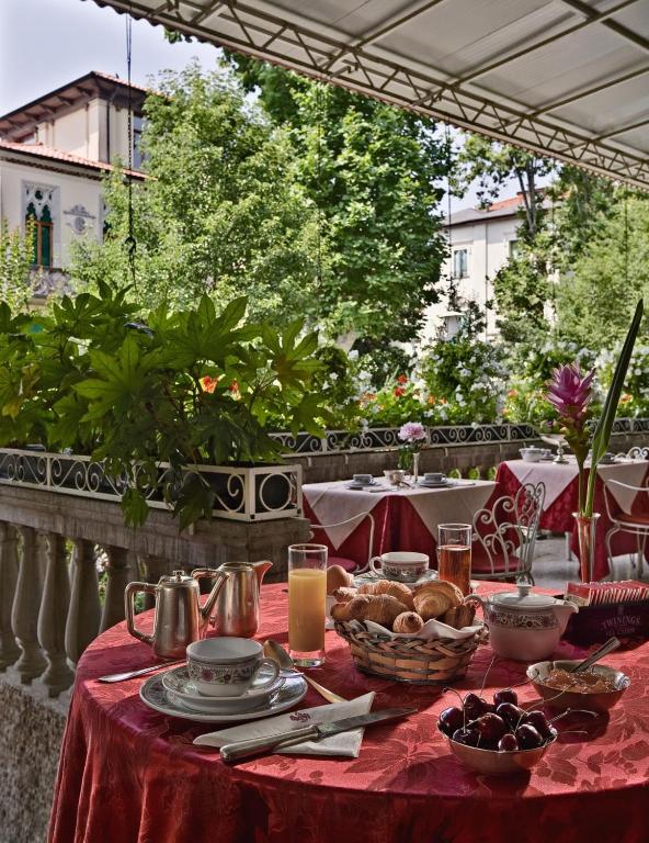 a table with a red table cloth with food on it at Hotel Biasutti in Venice-Lido