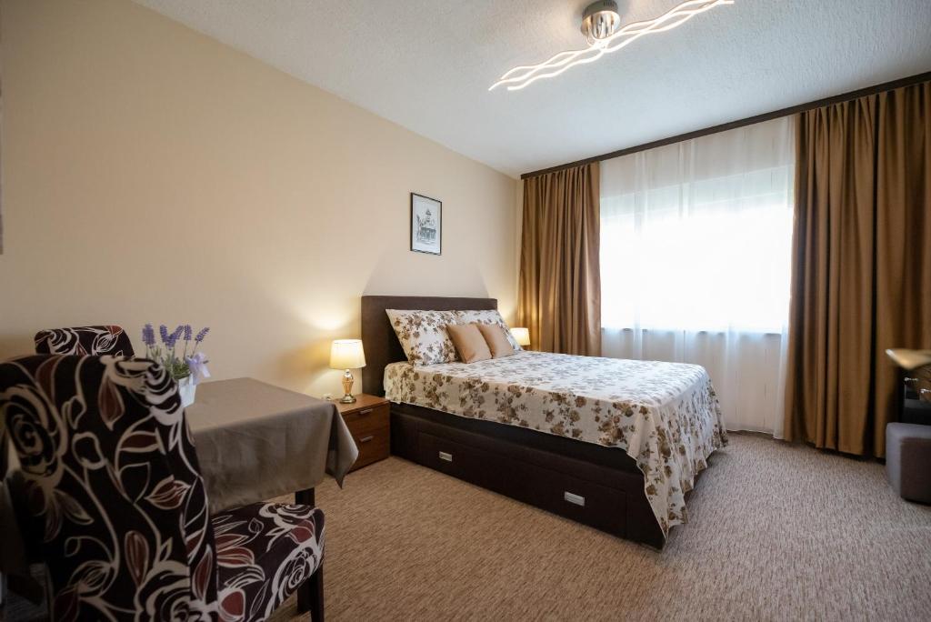 Postel nebo postele na pokoji v ubytování Apartmani Tome