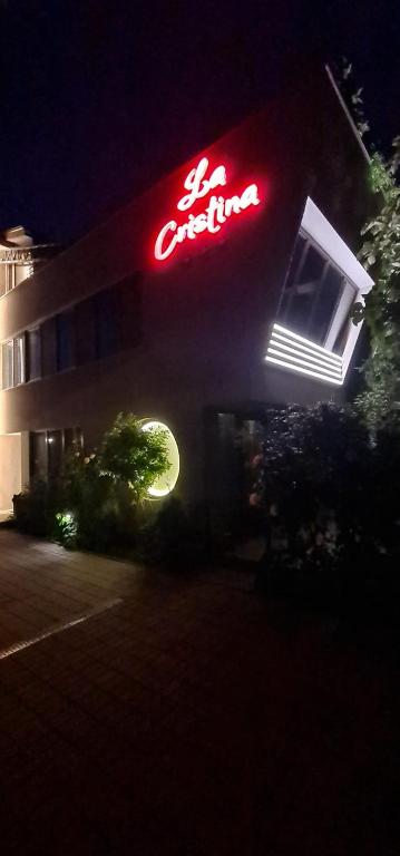 a lit up sign on the side of a building at La Cristina in Slatina